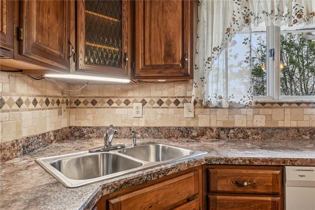 kitchen with dishwasher, sink, and backsplash