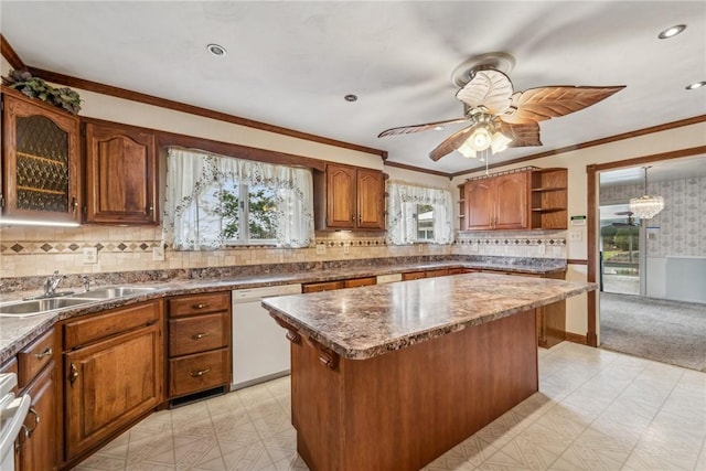 kitchen with a kitchen island, sink, ornamental molding, ceiling fan, and white dishwasher