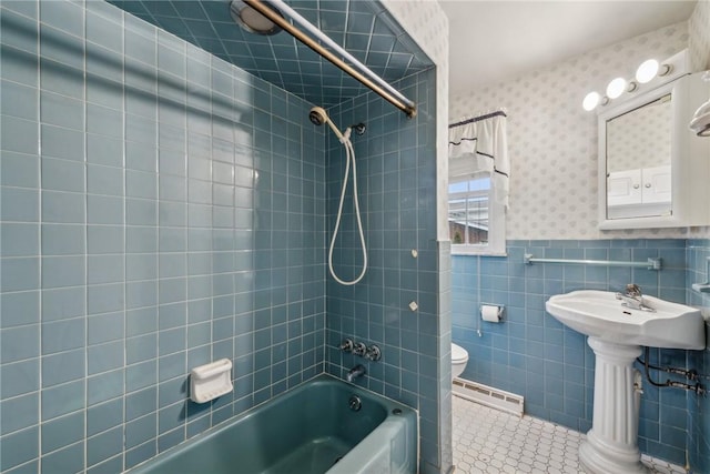 bathroom with toilet, tile walls, baseboard heating, tiled shower / bath combo, and tile patterned flooring