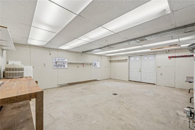 basement with a paneled ceiling