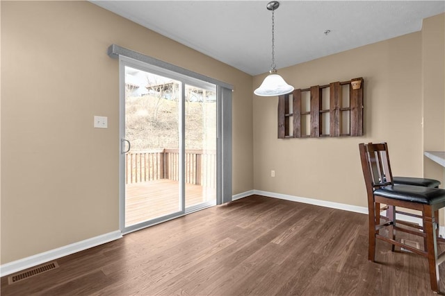 dining space featuring dark wood-type flooring