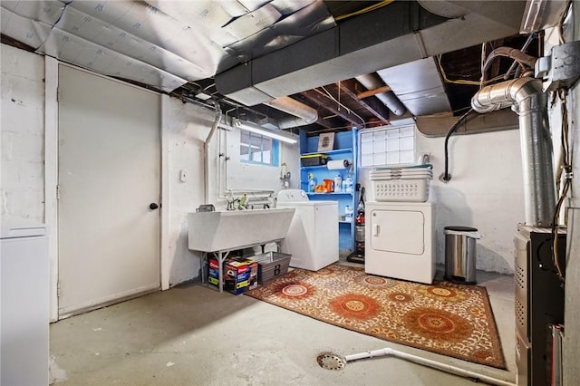 basement featuring sink and washer and dryer