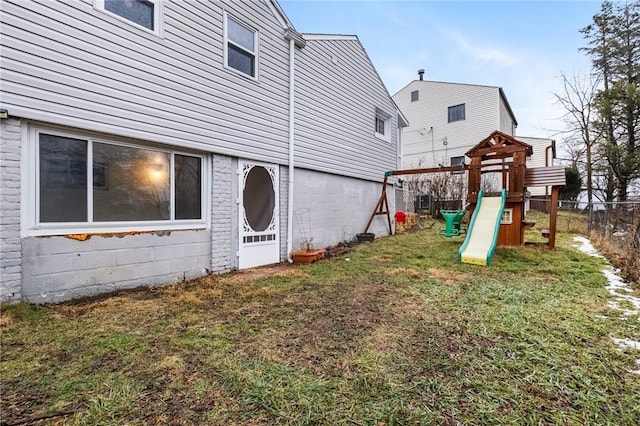 exterior space with a playground and a lawn