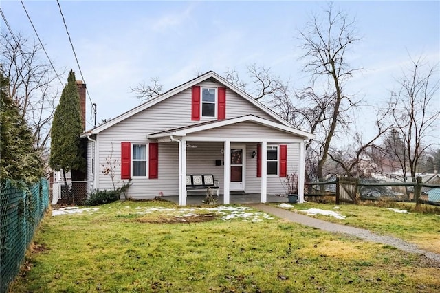 bungalow-style home featuring a front yard and covered porch