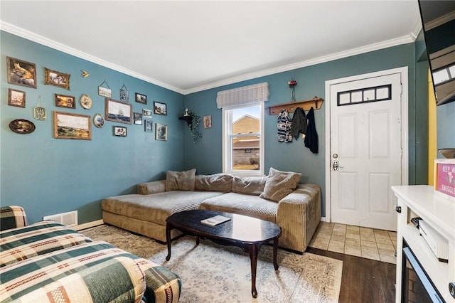 living room featuring crown molding and hardwood / wood-style flooring