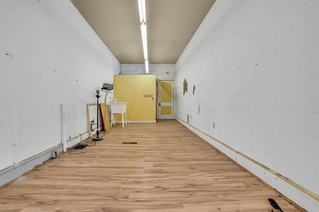 basement with light hardwood / wood-style flooring