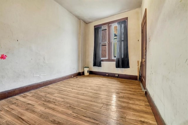 unfurnished room with wood-type flooring