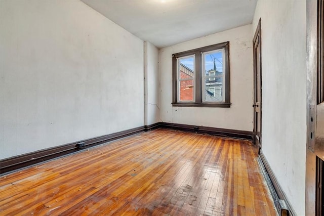 unfurnished room featuring hardwood / wood-style floors