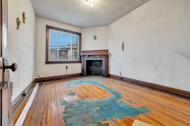 unfurnished living room featuring hardwood / wood-style flooring