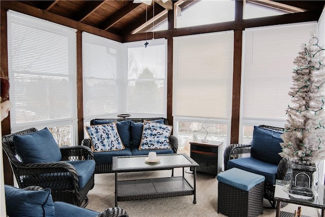 sunroom with wood ceiling, a healthy amount of sunlight, and vaulted ceiling with beams