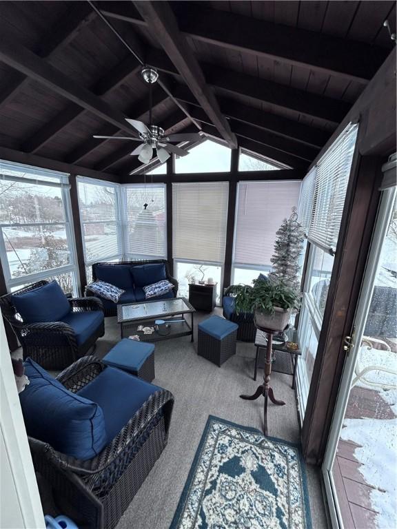 sunroom / solarium featuring vaulted ceiling with beams, wooden ceiling, and ceiling fan