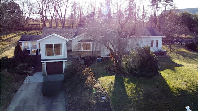 view of front facade with concrete driveway and an attached garage