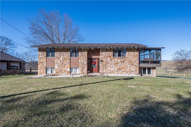 rear view of property with a sunroom and a lawn