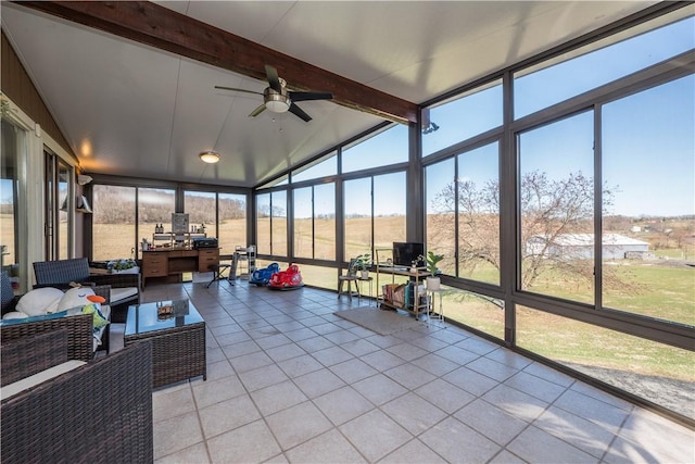 sunroom / solarium featuring lofted ceiling with beams and ceiling fan