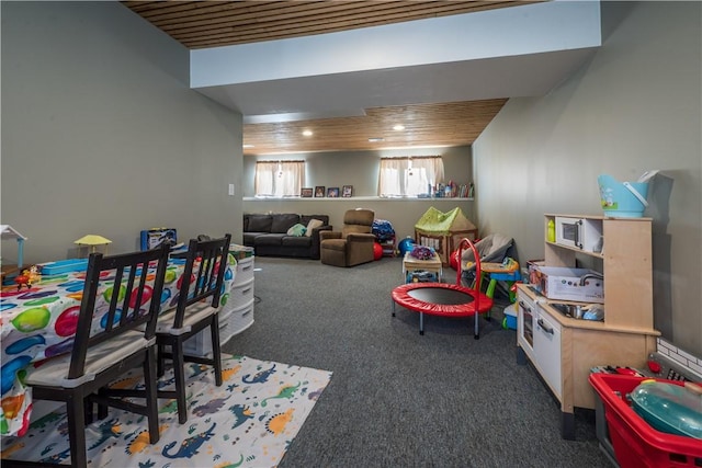 recreation room featuring dark carpet