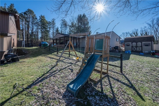 view of play area featuring a storage shed and a lawn