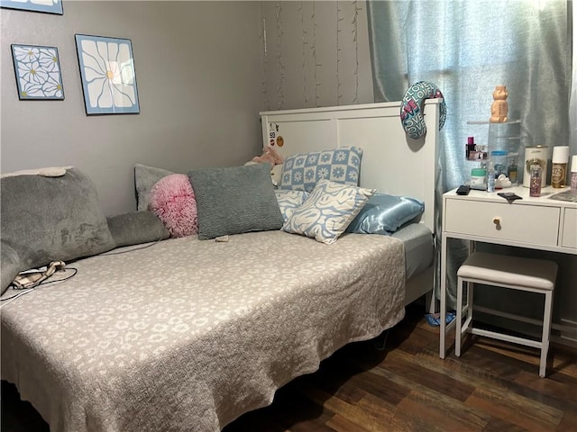 bedroom with dark wood-type flooring