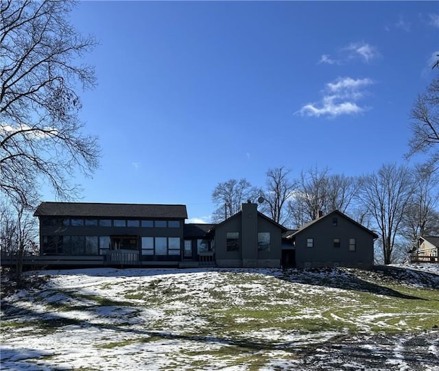 view of snow covered back of property