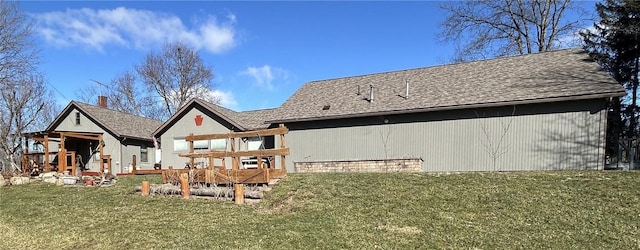 rear view of property featuring a yard