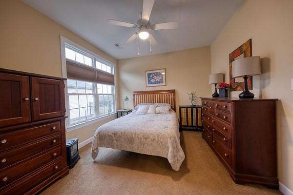 bedroom featuring light colored carpet and ceiling fan