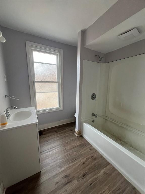 bathroom with vanity, wood-type flooring, and shower / tub combination