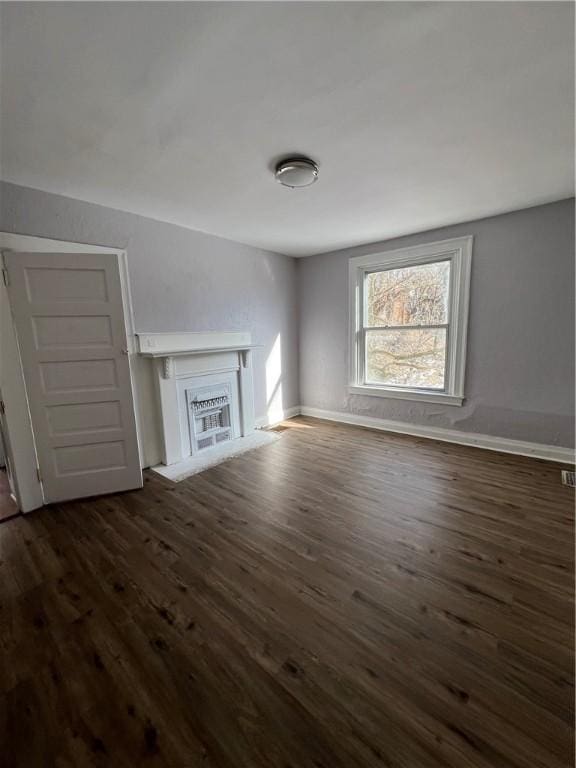 unfurnished living room with dark hardwood / wood-style flooring