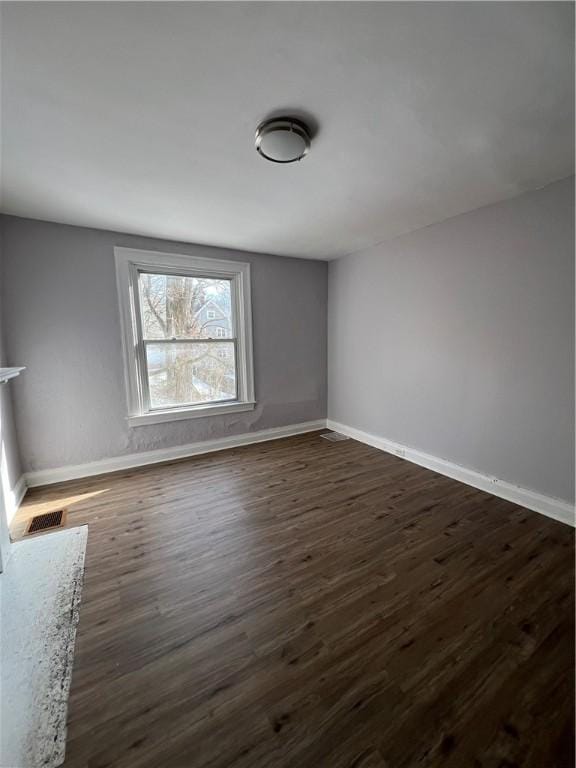 empty room featuring dark hardwood / wood-style floors