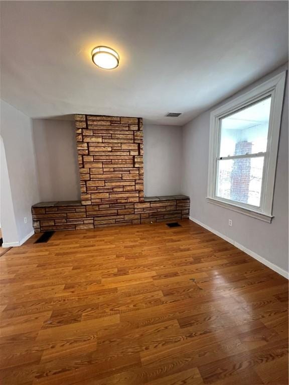 unfurnished living room with wood-type flooring