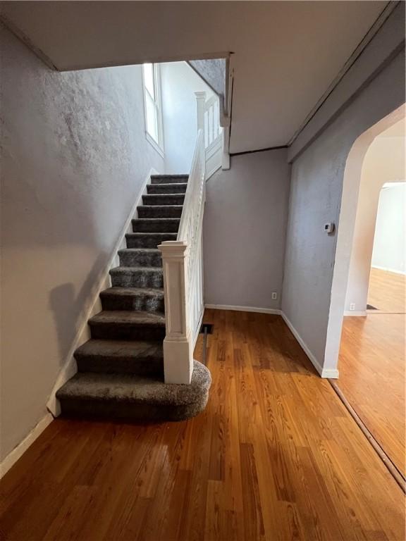 staircase featuring wood-type flooring