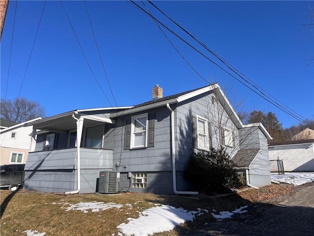 snow covered property featuring a balcony and central air condition unit