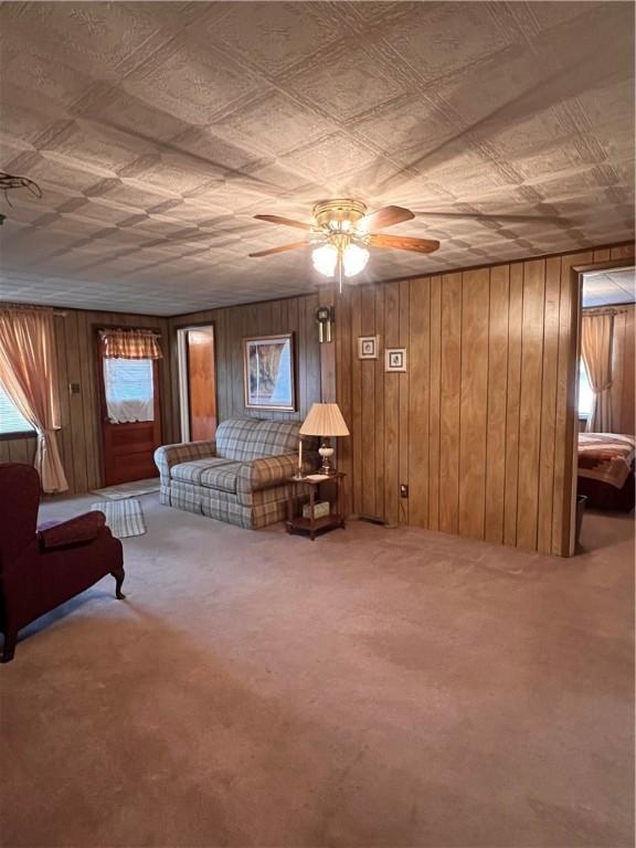 carpeted bedroom featuring wooden walls