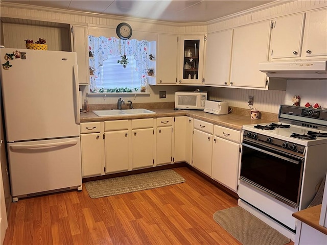 kitchen featuring sink, light wood-type flooring, pendant lighting, white appliances, and white cabinets