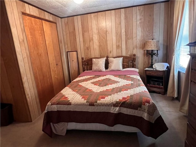 bedroom with a closet, carpet, and wood walls