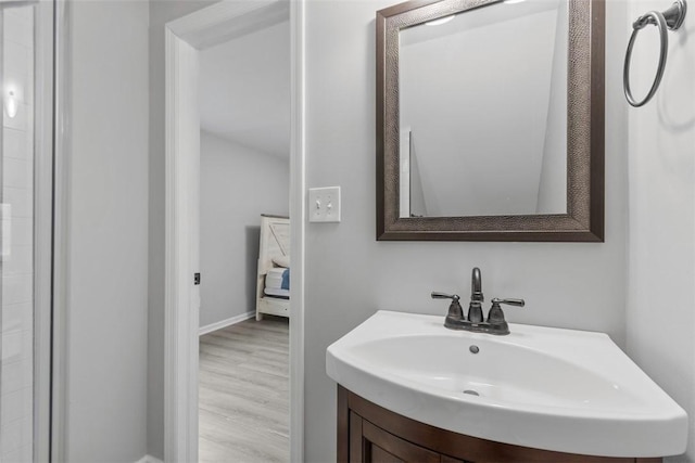 bathroom with vanity and hardwood / wood-style floors