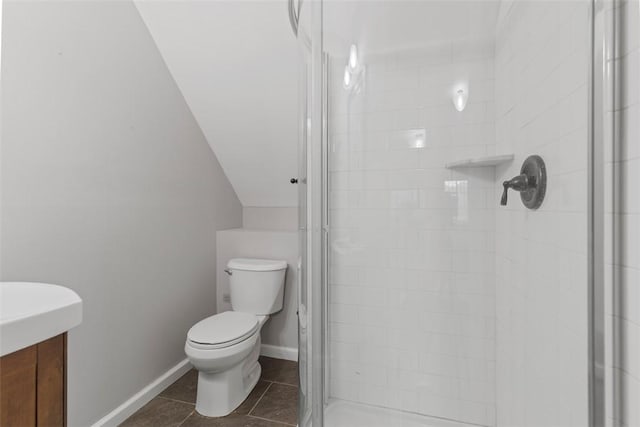 bathroom with lofted ceiling, tile patterned flooring, vanity, a shower with shower door, and toilet