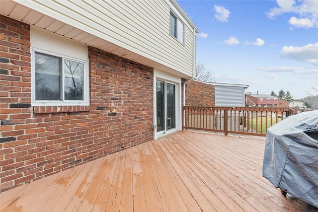 wooden terrace featuring a grill