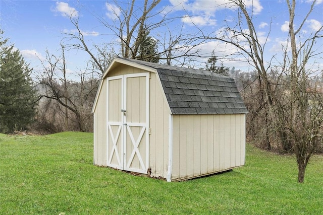 view of outbuilding featuring a yard