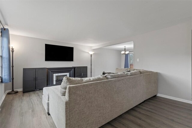 living room with hardwood / wood-style floors and a notable chandelier