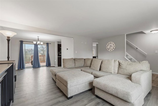 living room with a notable chandelier and light hardwood / wood-style flooring