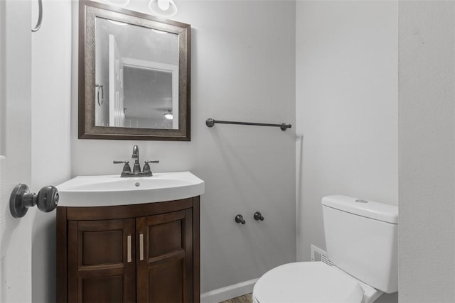 bathroom featuring vanity and toilet