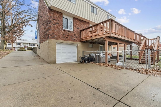 back of house featuring a garage and a wooden deck