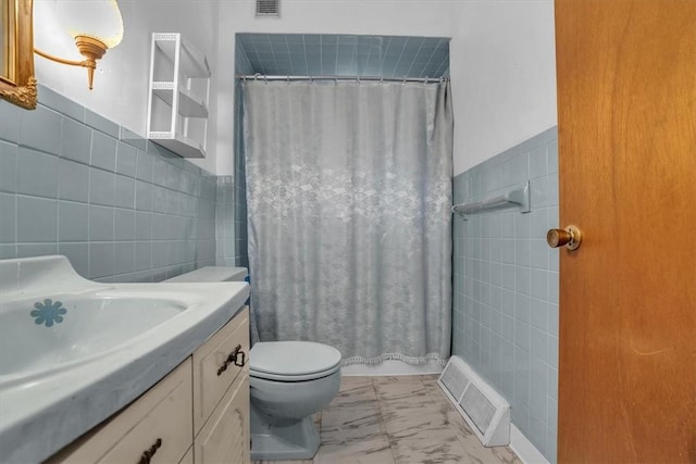 bathroom featuring vanity, tile walls, a shower with shower curtain, and toilet