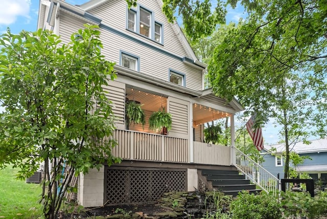 view of side of property with a porch