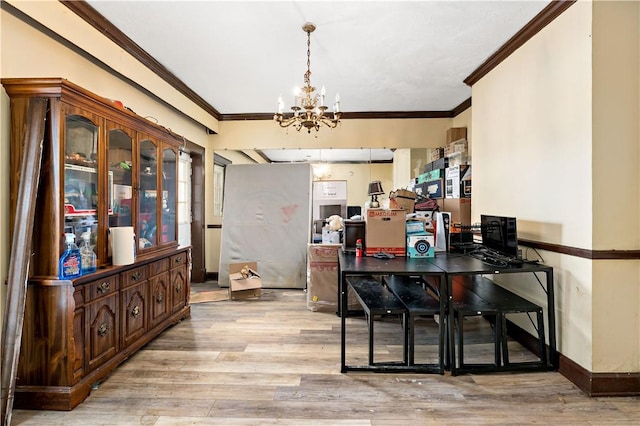 dining space with crown molding, light hardwood / wood-style flooring, and a chandelier