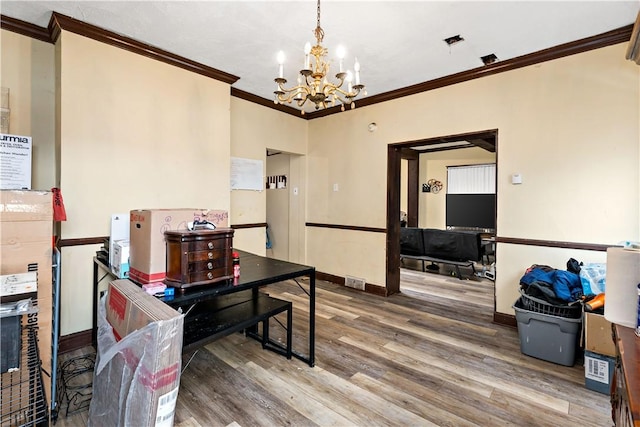 interior space featuring crown molding, hardwood / wood-style floors, and a notable chandelier