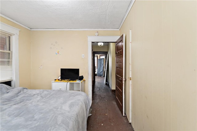 bedroom with ornamental molding and a textured ceiling