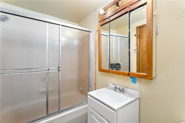 bathroom with vanity and enclosed tub / shower combo