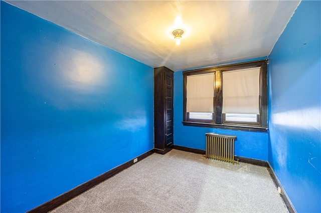 unfurnished room with carpet floors and radiator