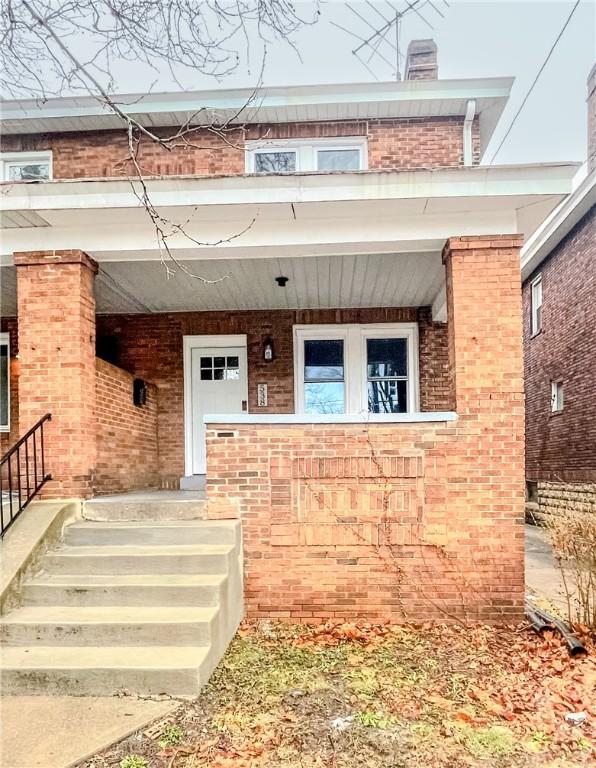 doorway to property featuring covered porch