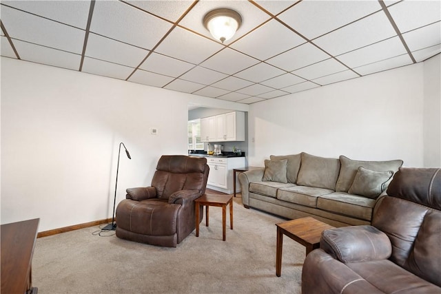 living room with light colored carpet and a drop ceiling